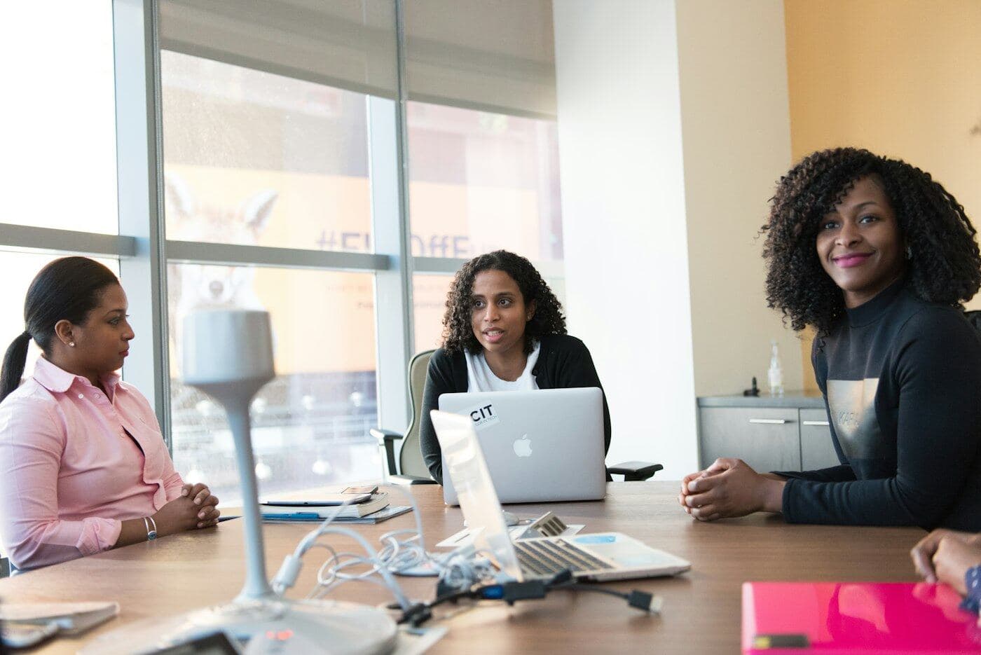 Three colleagues working together at a table